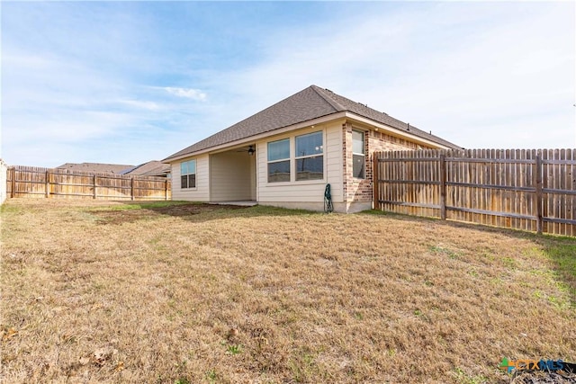 view of side of home featuring a yard