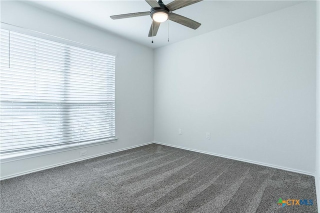 carpeted empty room featuring ceiling fan