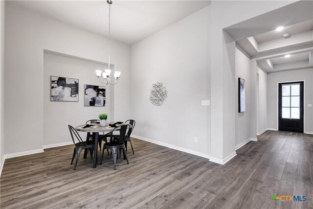 513 Foxbrook Way, Cibolo, TX 78108 - dining room featuring wood finished floors, baseboards, a chandelier, and a raised ceiling