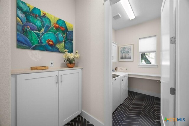 105 Monterey Oak Trl, Georgetown, TX 78628 - laundry area with independent washer and dryer, cabinet space, baseboards, and tile patterned flooring