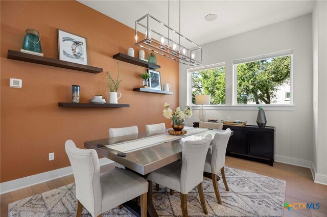 105 Monterey Oak Trl, Georgetown, TX 78628 - dining room featuring a chandelier, wood finished floors, and baseboards