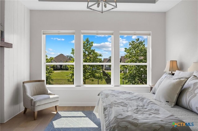 105 Monterey Oak Trl, Georgetown, TX 78628 - bedroom featuring multiple windows, wood finished floors, and a chandelier