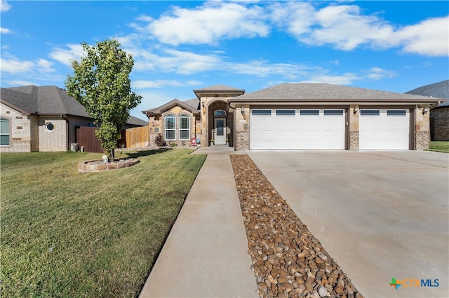 view of front of property with a garage and a front lawn