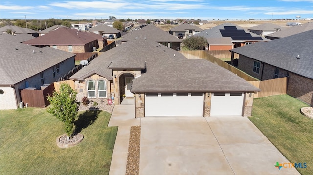 view of front of house with a front yard and a garage