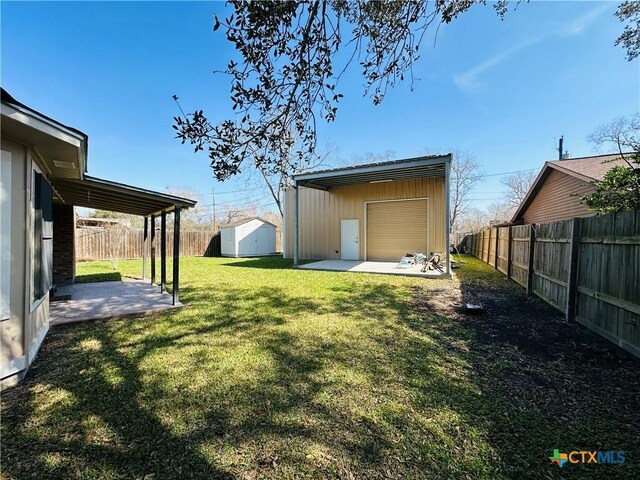 225 Monterrey Dr, Victoria, TX 77904 - view of yard featuring a fenced backyard, a shed, an outbuilding, and a patio