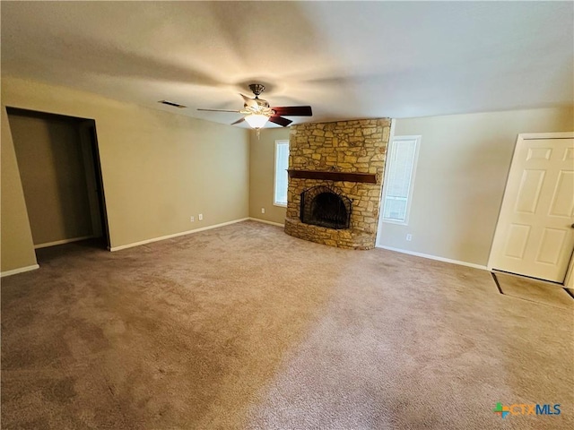 225 Monterrey Dr, Victoria, TX 77904 - unfurnished living room with ceiling fan, a fireplace, carpet flooring, visible vents, and baseboards