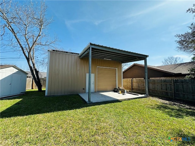 225 Monterrey Dr, Victoria, TX 77904 - back of house featuring a yard, a fenced backyard, an outdoor structure, and a patio