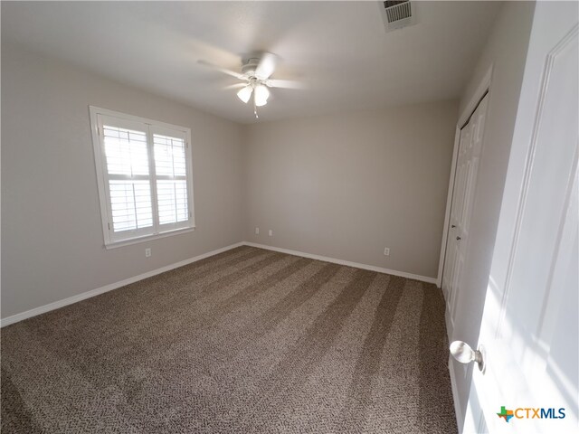 unfurnished bedroom with carpet flooring, ceiling fan, and a closet