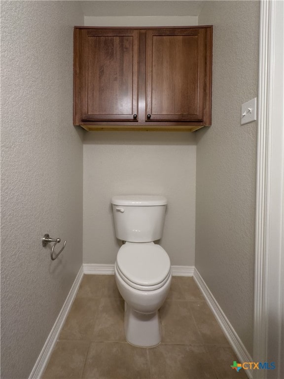 bathroom featuring tile patterned flooring and toilet