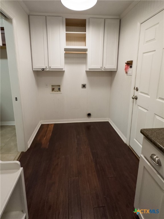 clothes washing area featuring cabinets, dark hardwood / wood-style floors, hookup for a washing machine, and electric dryer hookup