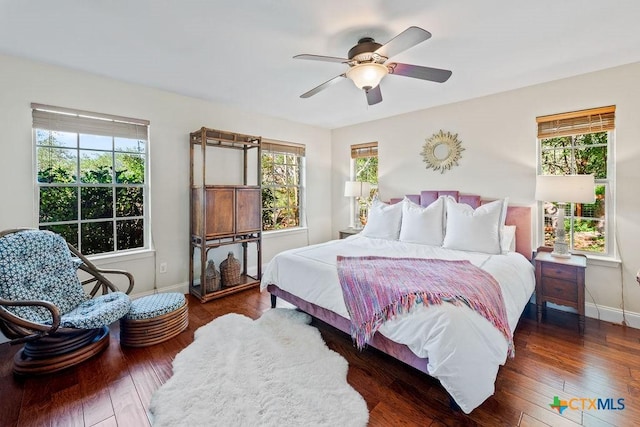 200 W Meadow Ln, Wimberley, TX 78676 - bedroom featuring baseboards, wood finished floors, and ceiling fan