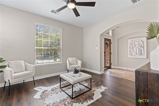 3312 Cortes Pl, Round Rock, TX 78665 - living area with arched walkways, ceiling fan, wood finished floors, and baseboards