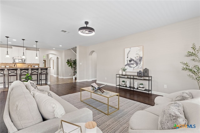 3312 Cortes Pl, Round Rock, TX 78665 - living area featuring arched walkways, dark wood-type flooring, baseboards, and recessed lighting
