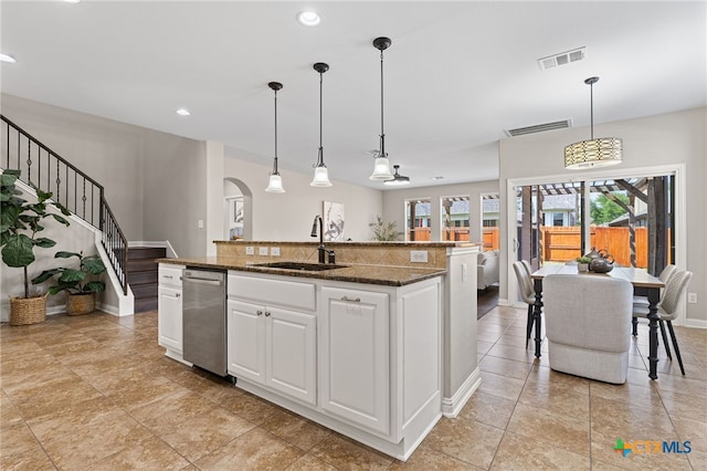 3312 Cortes Pl, Round Rock, TX 78665 - kitchen featuring dishwasher, a sink, arched walkways, white cabinetry, and baseboards