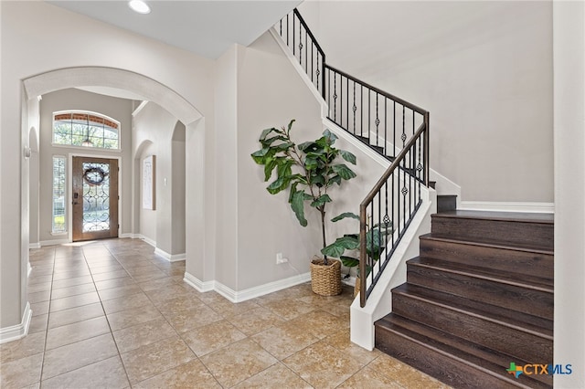 3312 Cortes Pl, Round Rock, TX 78665 - tiled entrance foyer featuring arched walkways, baseboards, and stairs