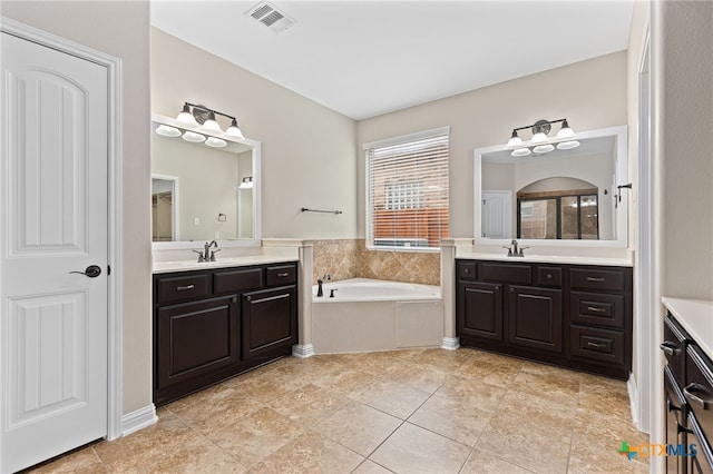 3312 Cortes Pl, Round Rock, TX 78665 - full bath with two vanities, a bath, and tile patterned floors