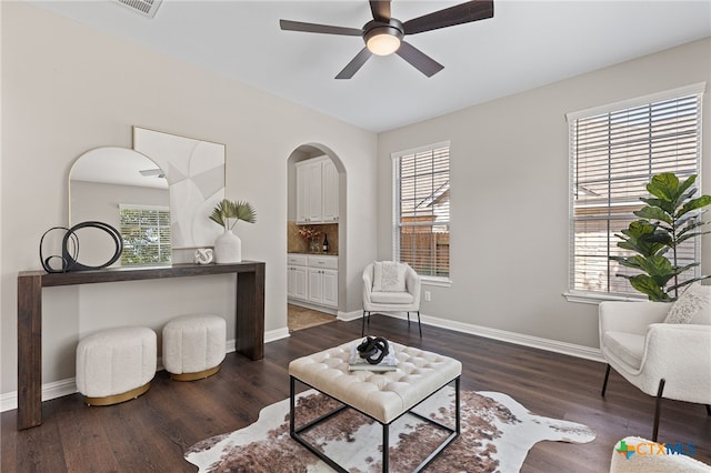3312 Cortes Pl, Round Rock, TX 78665 - sitting room featuring a ceiling fan, dark wood finished floors, baseboards, and arched walkways