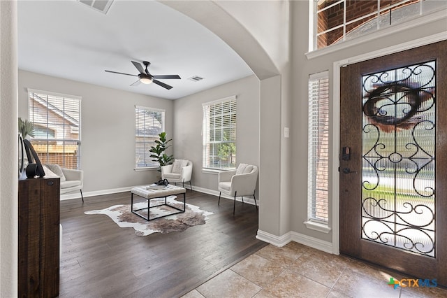 3312 Cortes Pl, Round Rock, TX 78665 - foyer featuring arched walkways, a ceiling fan, baseboards, and wood finished floors