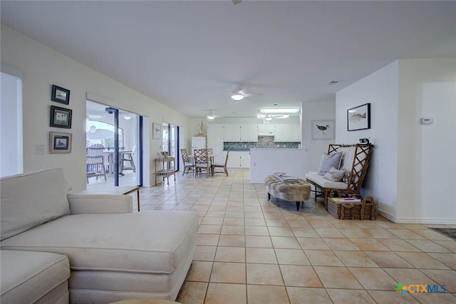 living room with ceiling fan and light tile patterned flooring