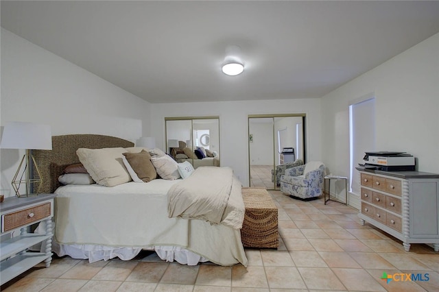 tiled bedroom with multiple closets