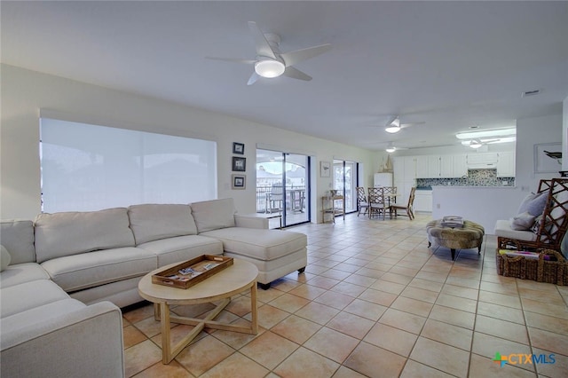 living room with ceiling fan and light tile patterned flooring