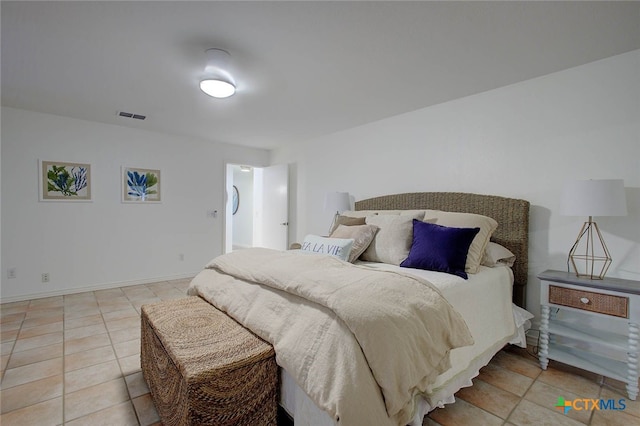 bedroom with light tile patterned floors