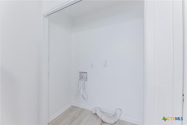 laundry room with laundry area, light wood-style flooring, hookup for an electric dryer, and baseboards