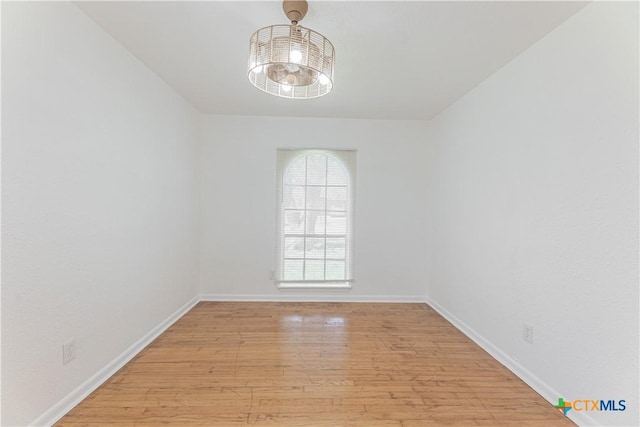 empty room with light wood-style flooring and baseboards