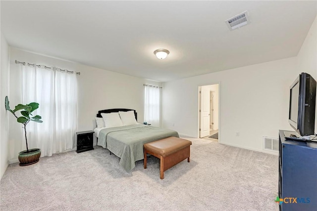 carpeted bedroom featuring connected bathroom