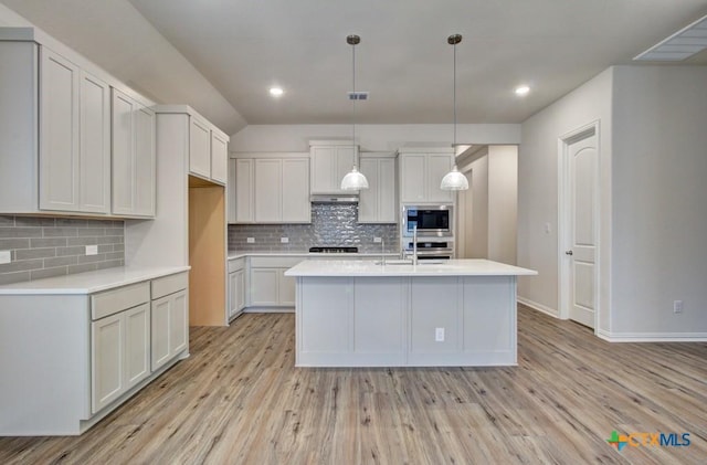 2055 Stephanie Ave, New Braunfels, TX 78132 - kitchen featuring appliances with stainless steel finishes, light wood-style flooring, light countertops, tasteful backsplash, and recessed lighting