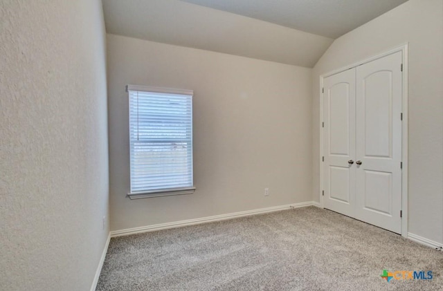 2055 Stephanie Ave, New Braunfels, TX 78132 - unfurnished bedroom with carpet floors, baseboards, vaulted ceiling, and a closet