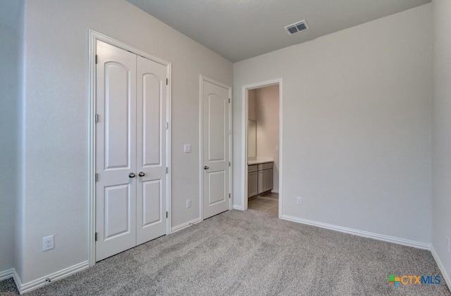 2055 Stephanie Ave, New Braunfels, TX 78132 - unfurnished bedroom with light carpet, baseboards, and ensuite bath