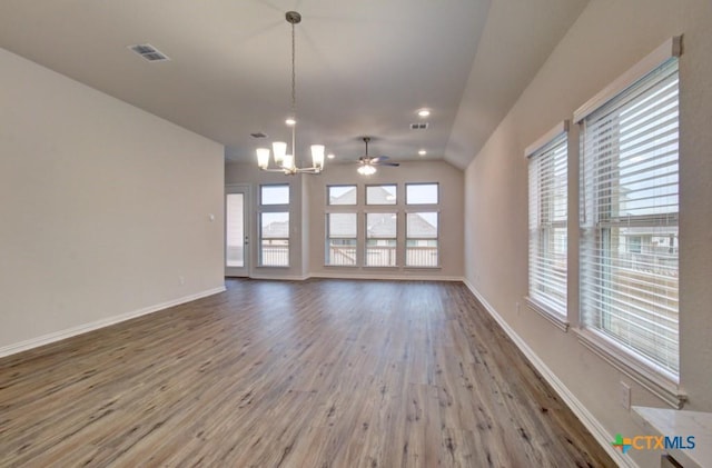 2055 Stephanie Ave, New Braunfels, TX 78132 - unfurnished living room featuring a chandelier, wood finished floors, lofted ceiling, baseboards, and a ceiling fan
