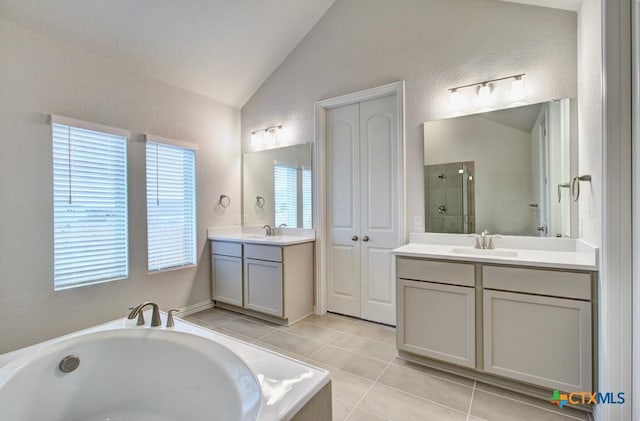 2055 Stephanie Ave, New Braunfels, TX 78132 - full bathroom with vaulted ceiling, a garden tub, two vanities, tile patterned flooring, and a tile shower