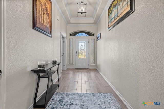 doorway featuring ornamental molding and a chandelier