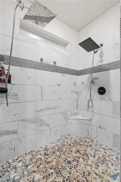 bathroom with tiled shower