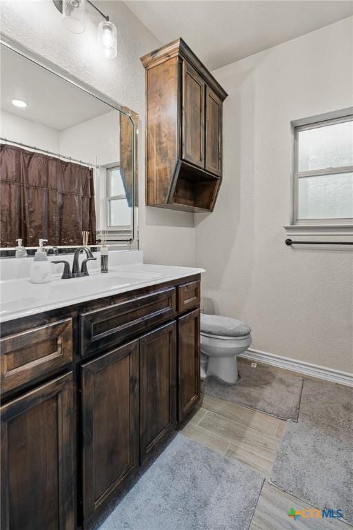 bathroom featuring toilet and vanity