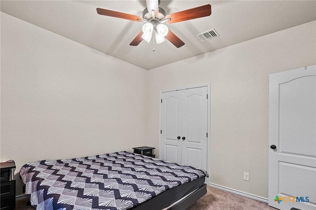 bedroom featuring ceiling fan, carpet flooring, and a closet