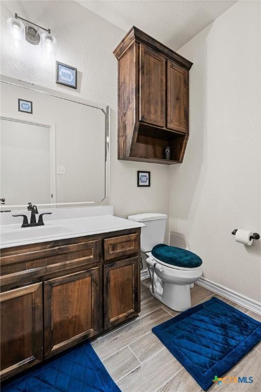 bathroom featuring toilet and vanity