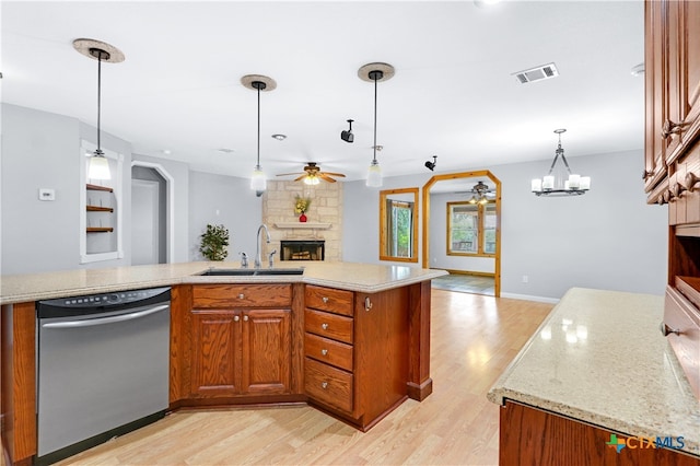 kitchen with dishwasher, light wood-type flooring, decorative light fixtures, and sink