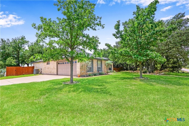 ranch-style house featuring central air condition unit, a front yard, and a garage