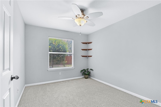 spare room featuring carpet flooring and ceiling fan