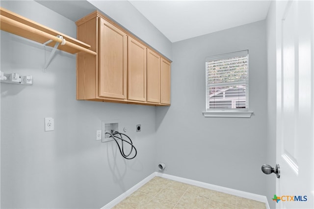 laundry area featuring electric dryer hookup, cabinets, light tile patterned floors, and washer hookup