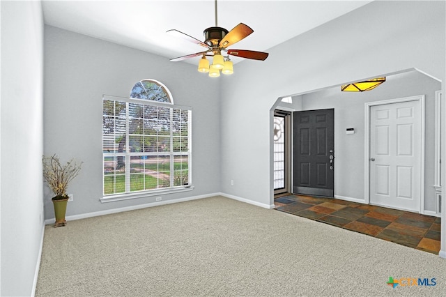 carpeted entryway with ceiling fan