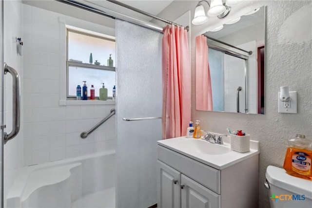 2308 Terrace Dr, Killeen, TX 76543 - bathroom featuring a shower with shower curtain, vanity, toilet, and a textured wall