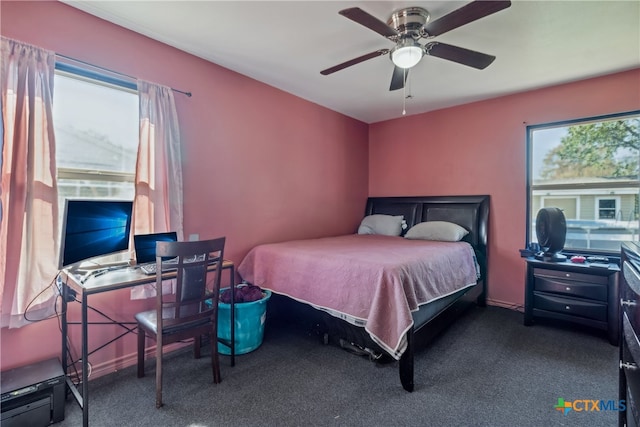 bedroom featuring ceiling fan and dark carpet