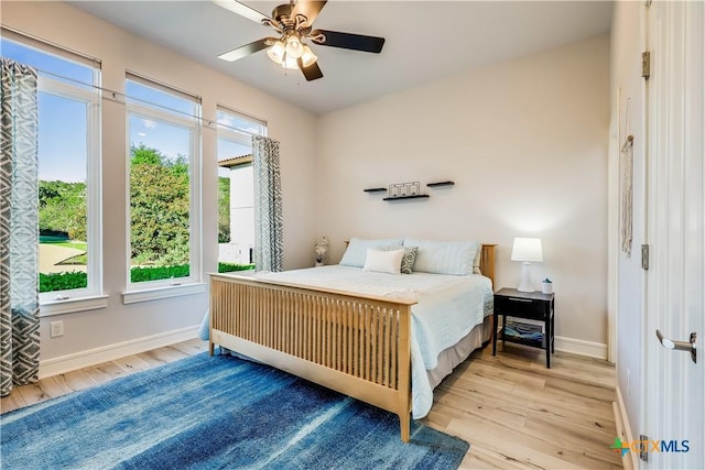 bedroom with light wood-type flooring and ceiling fan