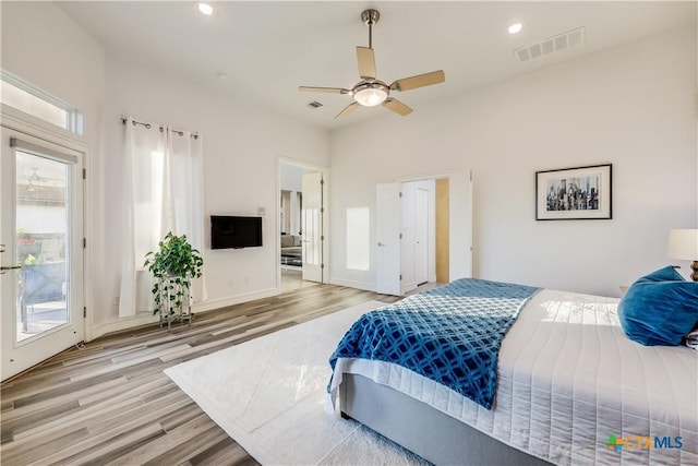 bedroom featuring ceiling fan, light hardwood / wood-style floors, and access to exterior