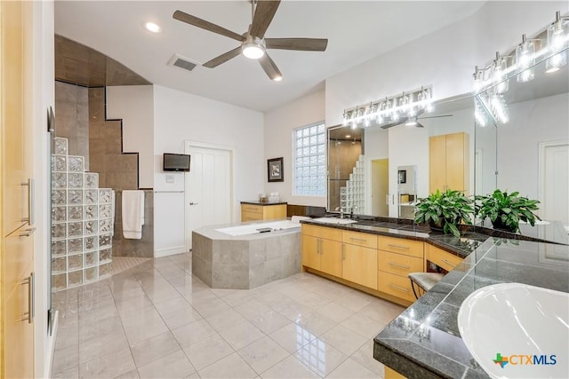 bathroom with tile patterned flooring, ceiling fan, separate shower and tub, and vanity