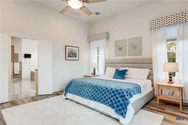 bedroom with multiple windows and ceiling fan